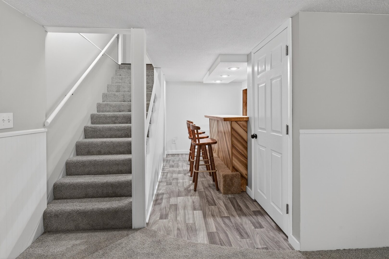 1136 4th Avenue North Clinton, IA 52732 - Photo 25 of 34 a view of a hallway with wooden floor and stairs