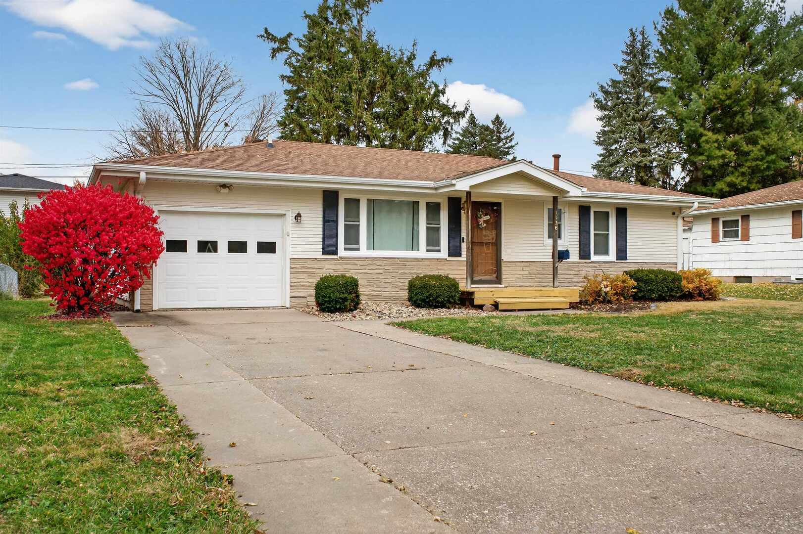 1136 4th Avenue North Clinton, IA 52732 - Photo 34 of 34 a front view of a house with a yard and potted plants