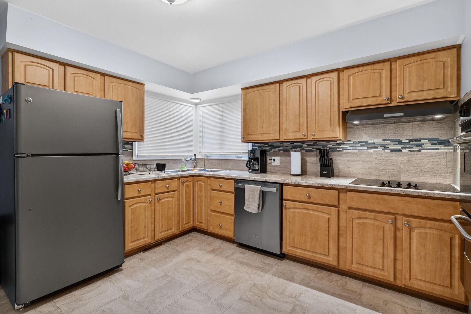 1136 4th Avenue North Clinton, IA 52732 - Photo 8 of 34 a kitchen with granite countertop a refrigerator stove top oven and sink