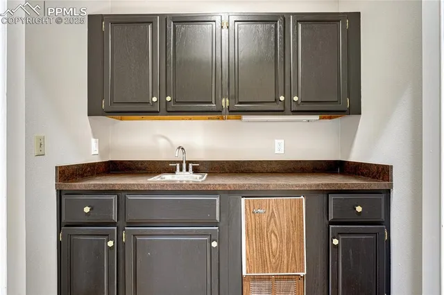 a view of cabinets with stainless steel appliances granite countertop cabinets and a window
