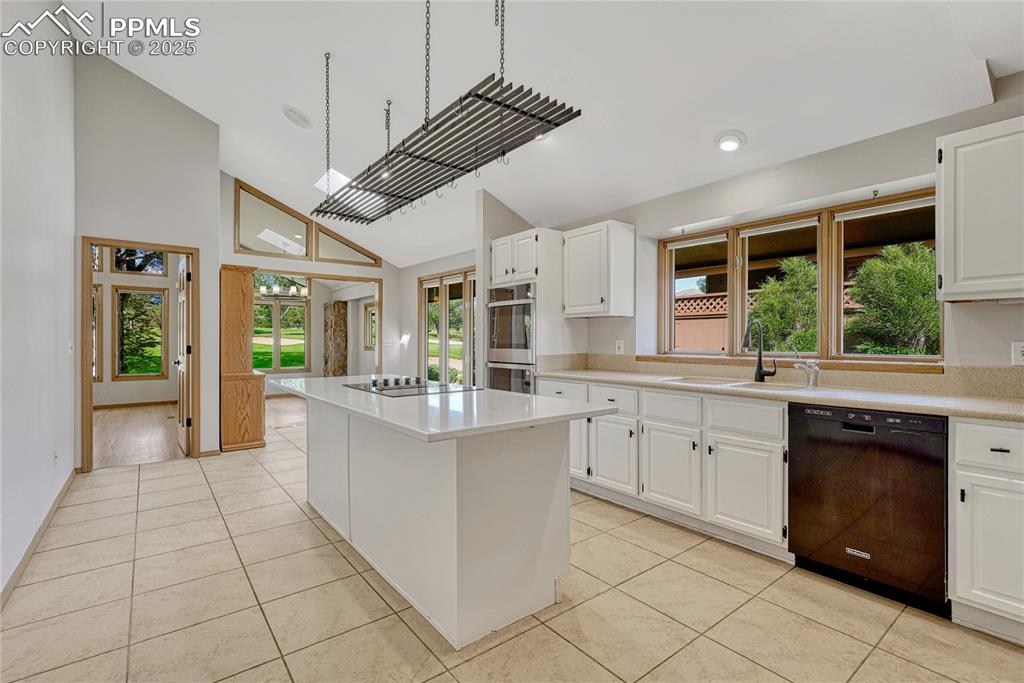 3120 Camels Ridge Lane Colorado Springs, CO 80904 - Photo 11 of 50 Vaulted Tiled Island Kitchen with Skylight