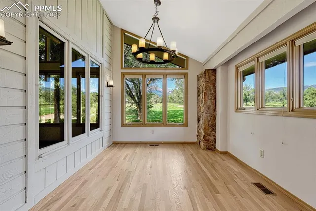 a view of an entryway with wooden floor