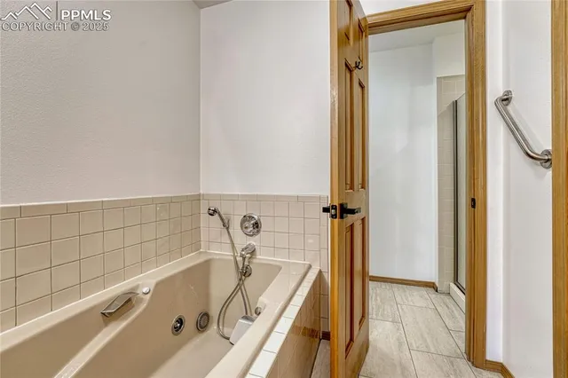 a bathroom with a tub and a shower