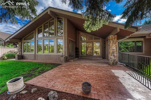 a view of a house with backyard and a porch