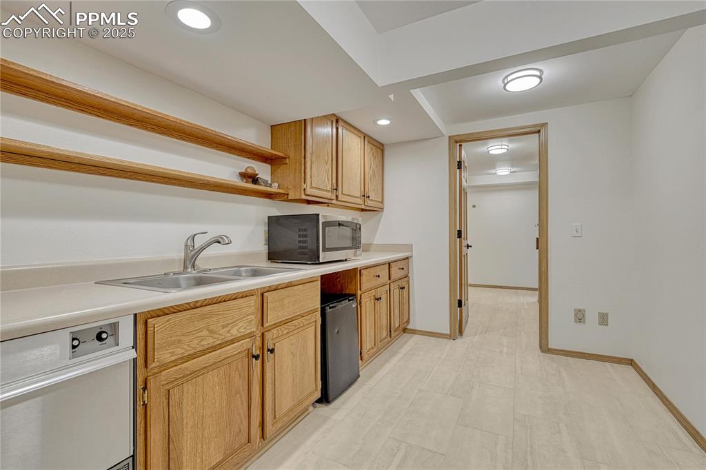 3120 Camels Ridge Lane Colorado Springs, CO 80904 - Photo 26 of 50 Lower Level Tiled Mini-Kitchen / Bar area with Ice Maker