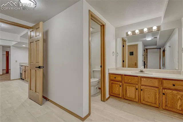 a spacious bathroom with a double vanity sink and a mirror