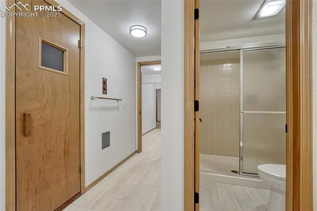 a bathroom with a shower and a glass door