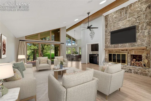 a living room with furniture a fireplace and a flat screen tv