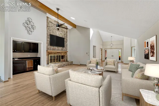 a living room with furniture fireplace and flat screen tv