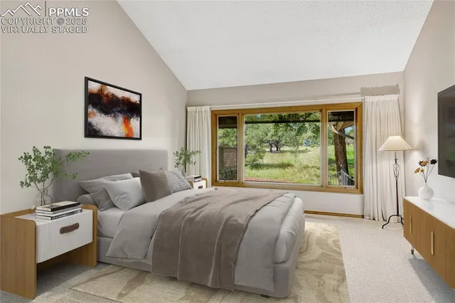 a bedroom with a large bed and a large window