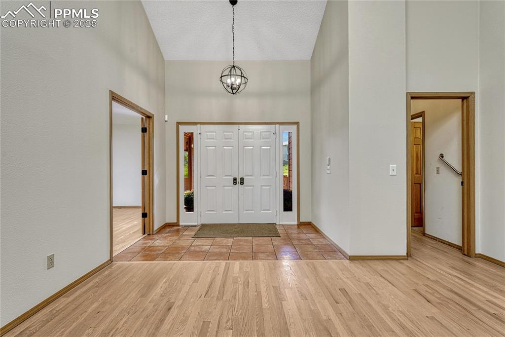 3120 Camels Ridge Lane Colorado Springs, CO 80904 - Photo 9 of 50 Vaulted Double Door Tiled Entry, Opens to Hardwood Floors