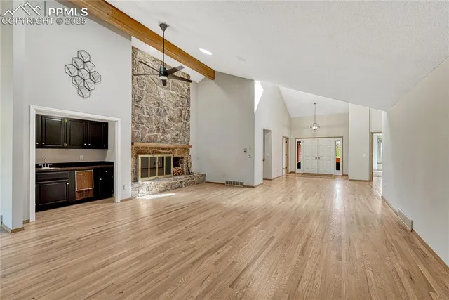 a view of a livingroom with wooden floor and a ceiling fan