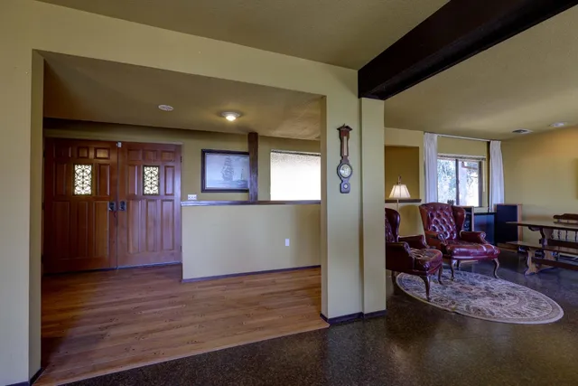 a view of a livingroom with furniture wooden floor and windows