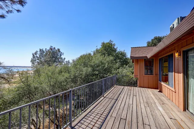 a balcony with wooden floor and city view