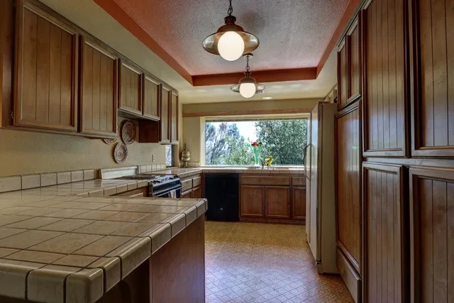 a kitchen with a stove a sink and a microwave