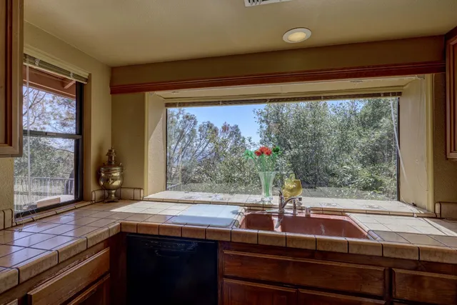 a room with pool table and windows