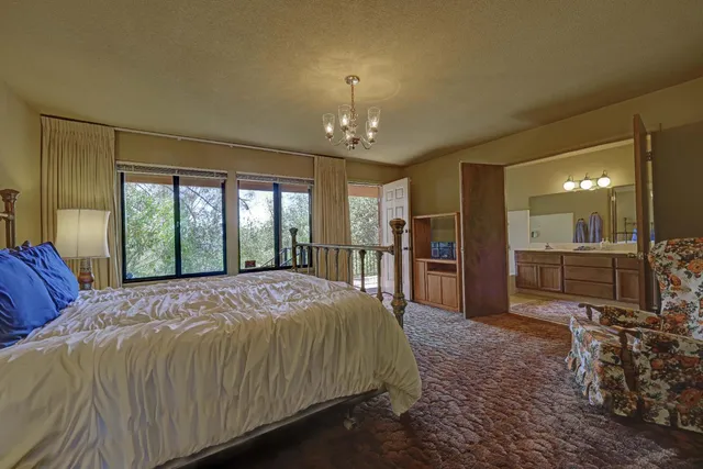 a spacious bedroom with a large bed and a dresser