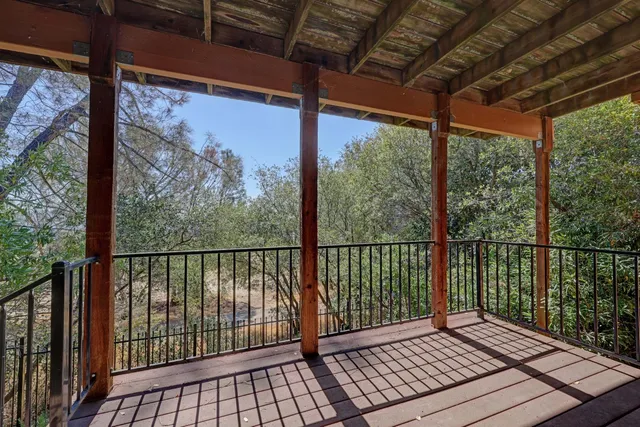 a view of a balcony with wooden floor