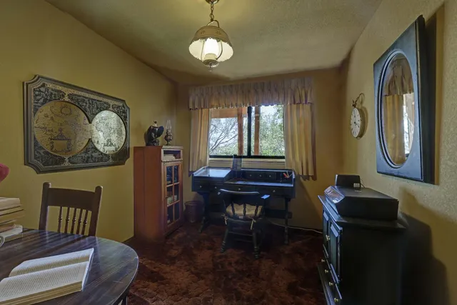 a view of a dining room with furniture and chandelier