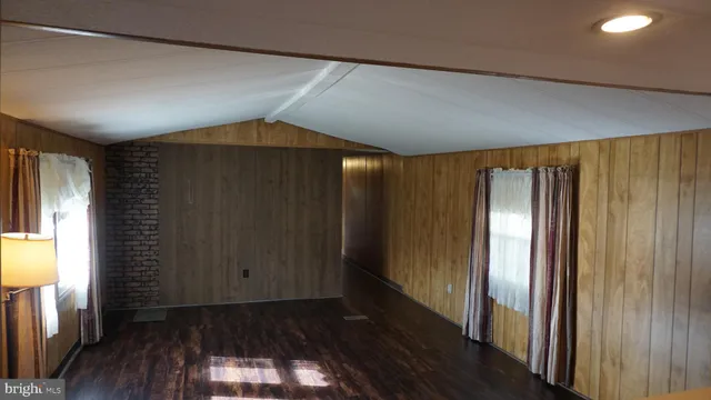 a view of an empty room and a window