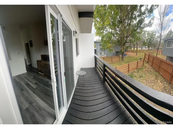 a view of a living room with furniture and wooden floor