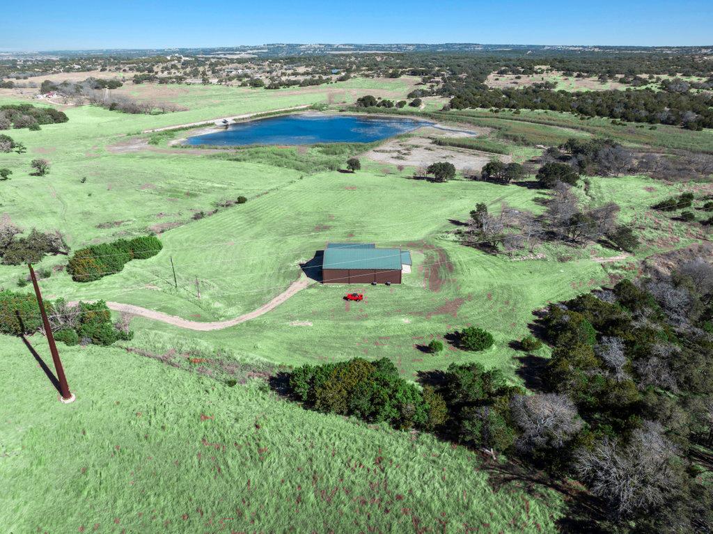 an aerial view of green landscape with trees