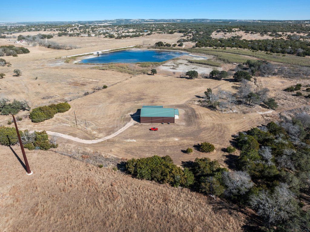 3259 Schumann Road Stonewall, TX 78671 - Photo 1 of 35 an aerial view of residential houses with outdoor space