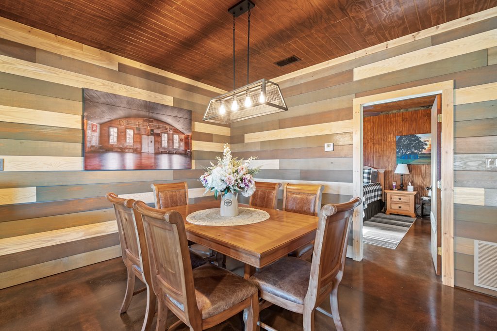 3259 Schumann Road Stonewall, TX 78671 - Photo 16 of 35 a view of a dining room with furniture window and wooden floor