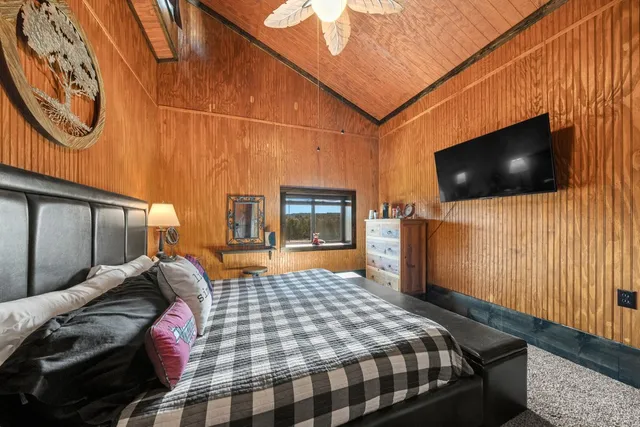 a bedroom with a bed and a large window with outer view