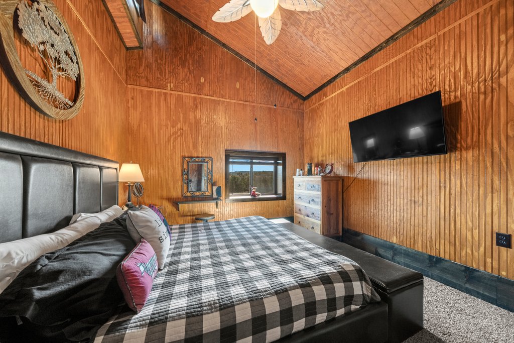 3259 Schumann Road Stonewall, TX 78671 - Photo 24 of 35 a bedroom with a bed and flat screen tv