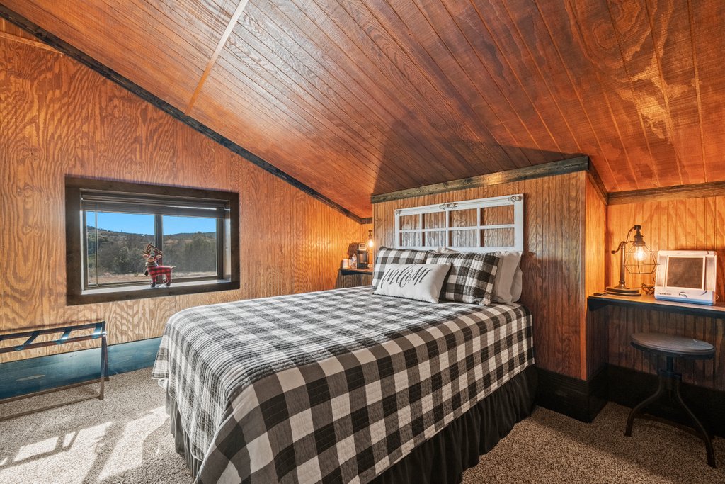 3259 Schumann Road Stonewall, TX 78671 - Photo 25 of 35 a bedroom with a bed and a large window with outer view