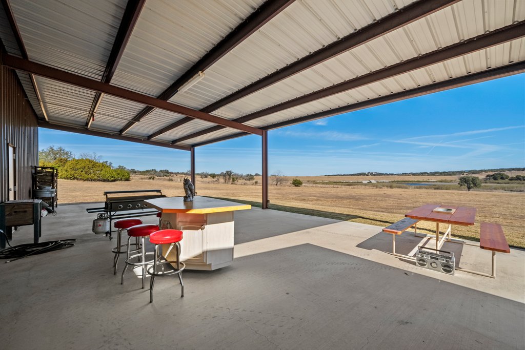 3259 Schumann Road Stonewall, TX 78671 - Photo 32 of 35 a view of a swimming pool with an outdoor seating