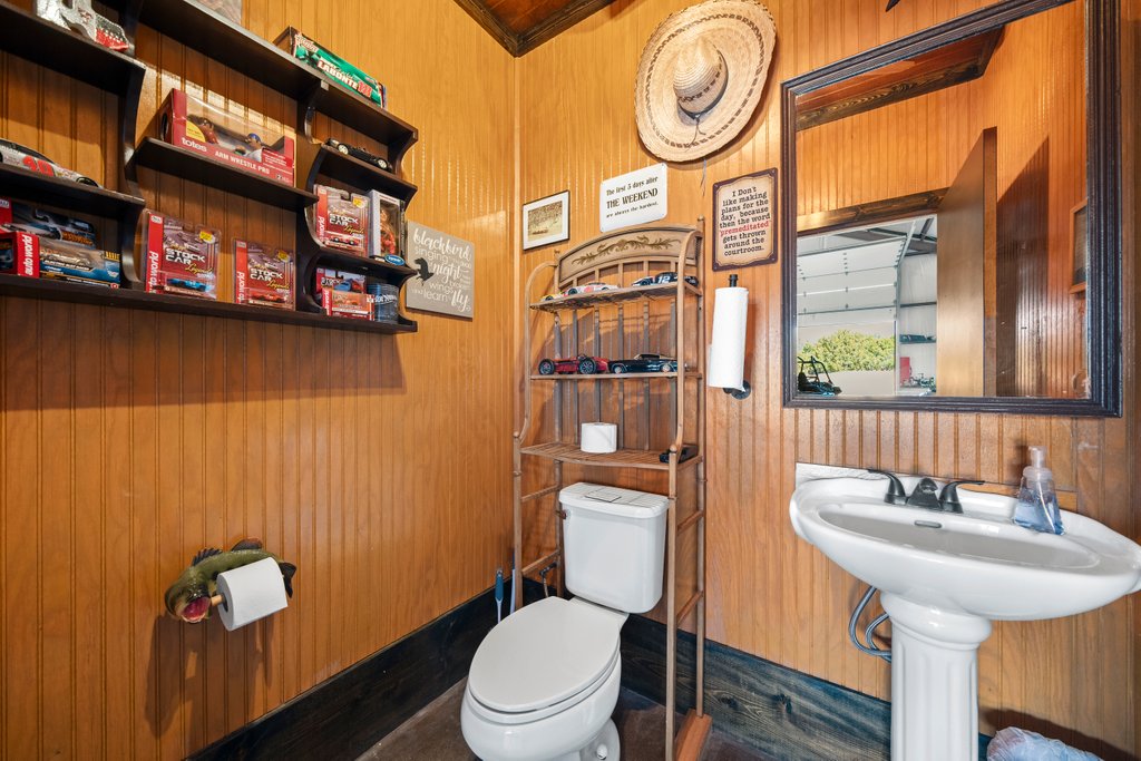 3259 Schumann Road Stonewall, TX 78671 - Photo 33 of 35 a bathroom with a sink a toilet and a mirror
