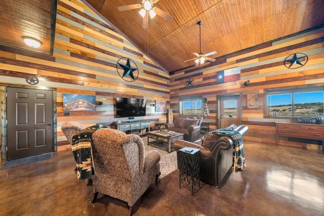 a living room with patio furniture and a flat screen tv