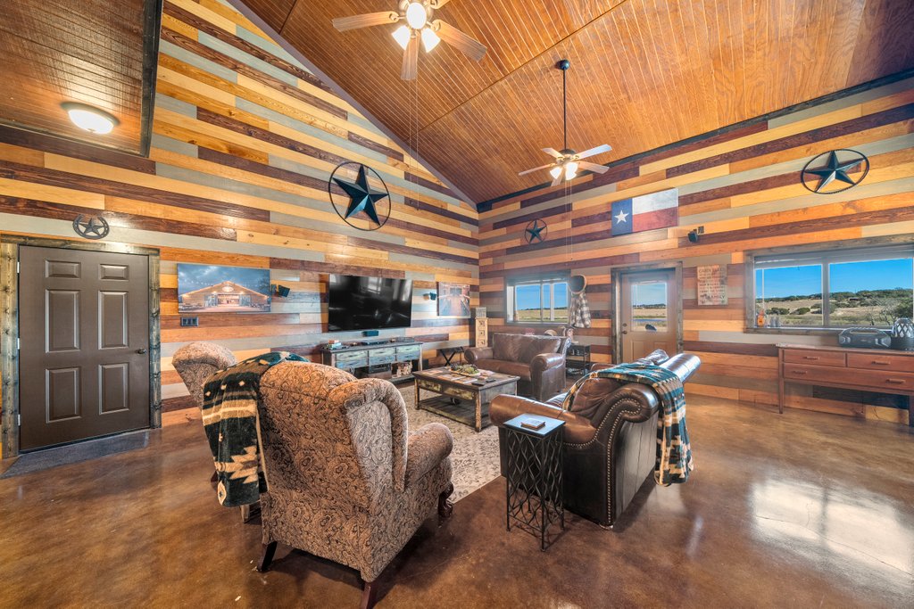 3259 Schumann Road Stonewall, TX 78671 - Photo 7 of 35 a living room with patio furniture and a flat screen tv