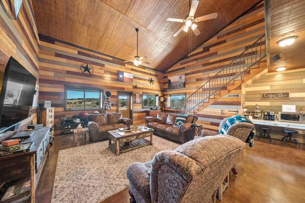 3259 Schumann Road Stonewall, TX 78671 - Photo 9 of 35 a living room with lots of furniture and a flat screen tv
