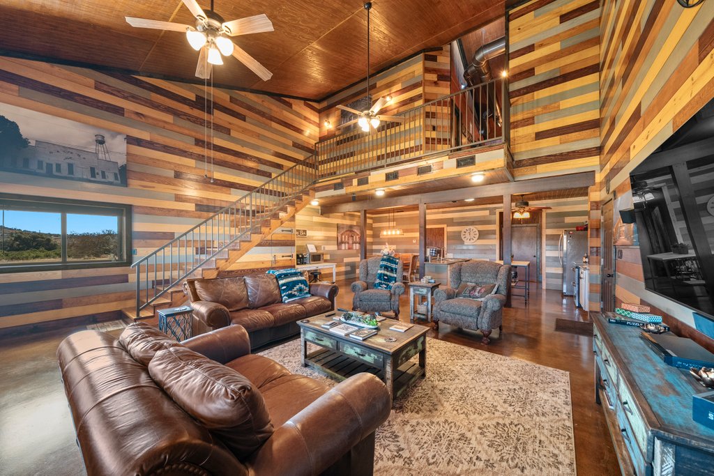 3259 Schumann Road Stonewall, TX 78671 - Photo 10 of 35 a media room with lots of chairs and a projector