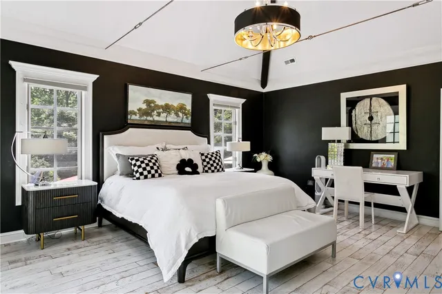 a bedroom with a bed and a large window