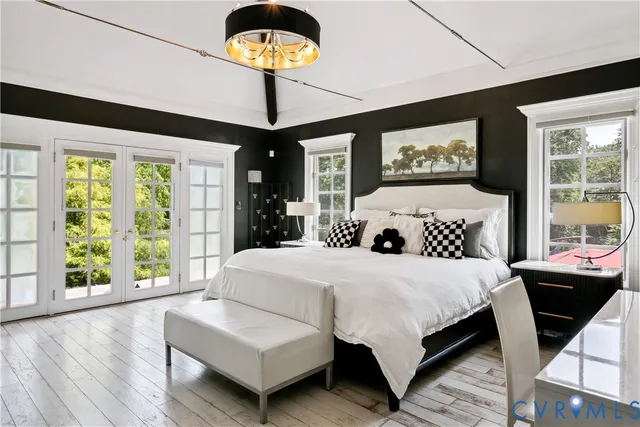 a bedroom with a bed and a large window