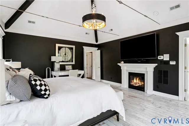 a bedroom with a bed and a fireplace