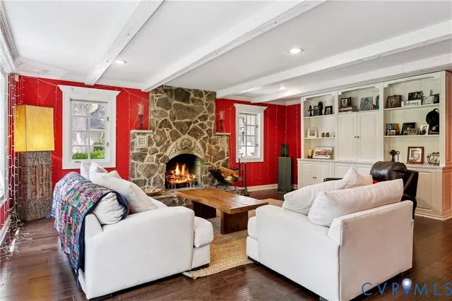 a living room with furniture a fireplace and a large window