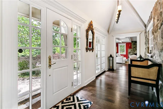 a view of an entryway with wooden floor and windows