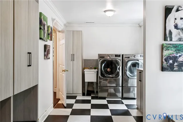 a view of a storage and utility room with washer and dryer