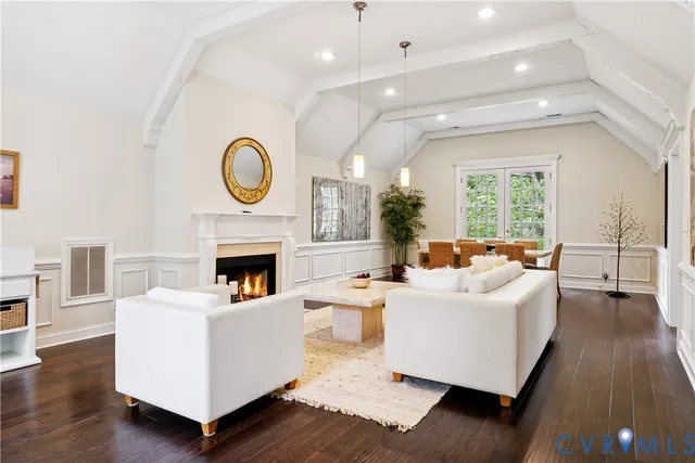 a living room with fireplace furniture and a wooden floor