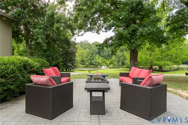 a view of a sitting area with furniture and a fire pit
