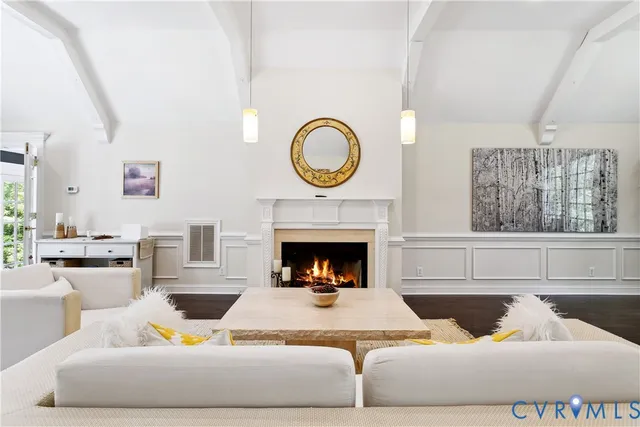 a living room with furniture a fireplace and window