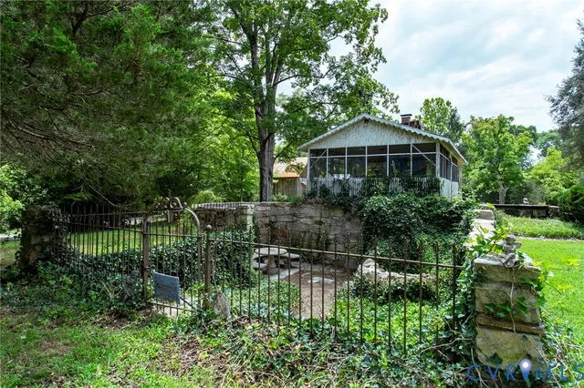 a view of a garden with large trees and plants