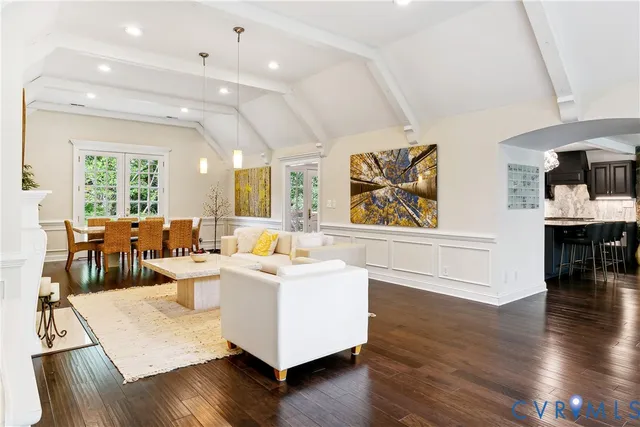 a living room with fireplace furniture and a wooden floor