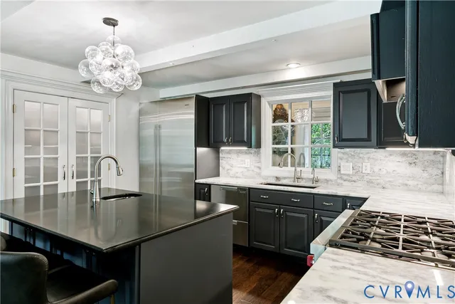 a kitchen with a sink and stainless steel appliances