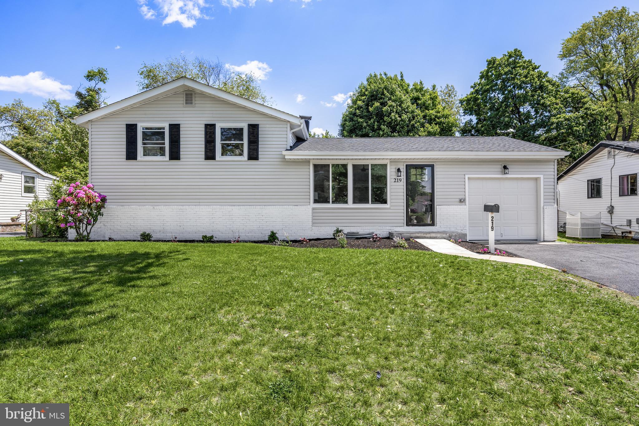 a front view of house with yard and green space